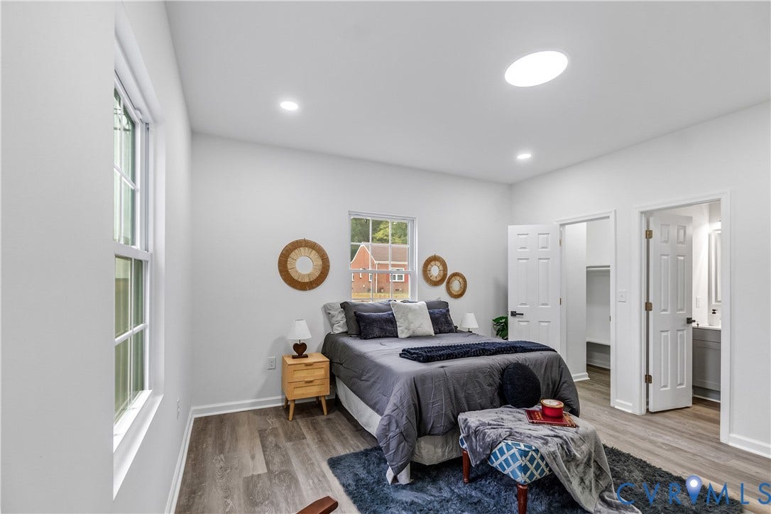 Vaulted ceiling with recessed lighting and skylight