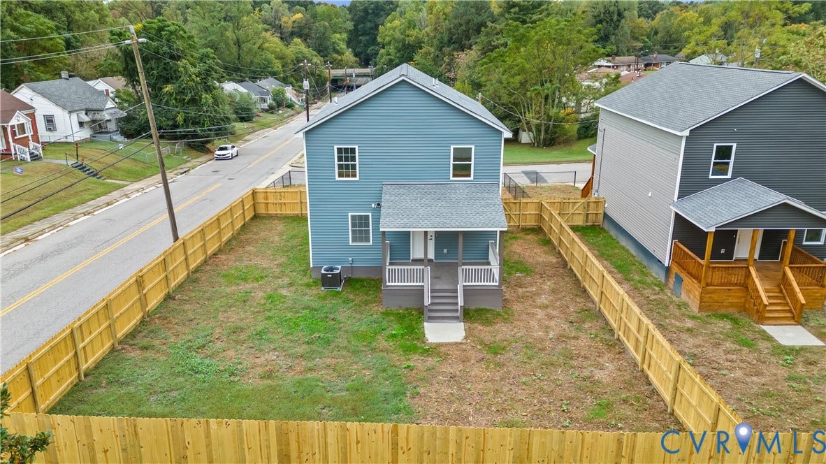Newly constructed two-story residence featuring blue siding, white trim windows, and a covered porch