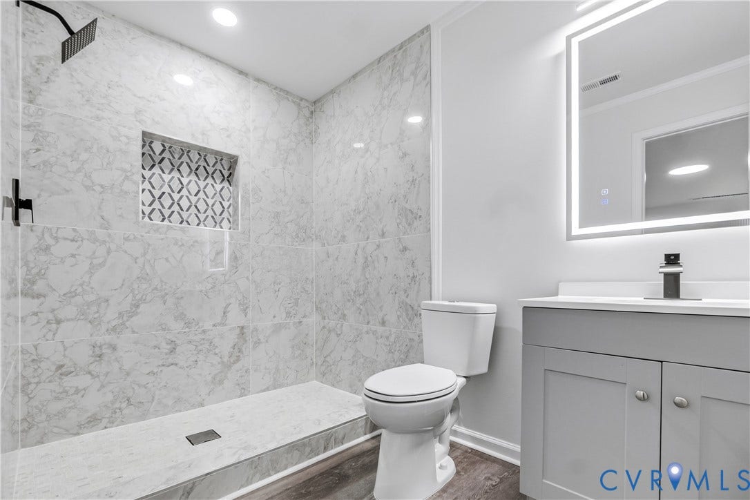 Walk-in shower with large format wall tiles and decorative niche