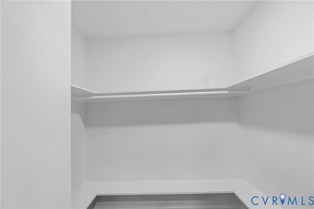 Built-in shelving and hanging rod with white finishes