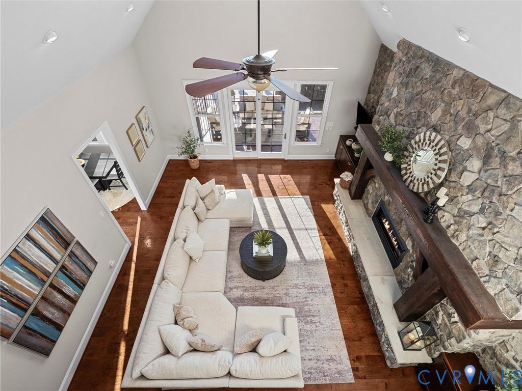 7750 Rock Cress Place, Chesterfield, VA 23120 Vaulted ceiling, floor-to-ceiling natural stone fireplace, heavy timber mantel, wood-finish flooring, and glass-paneled double doors
