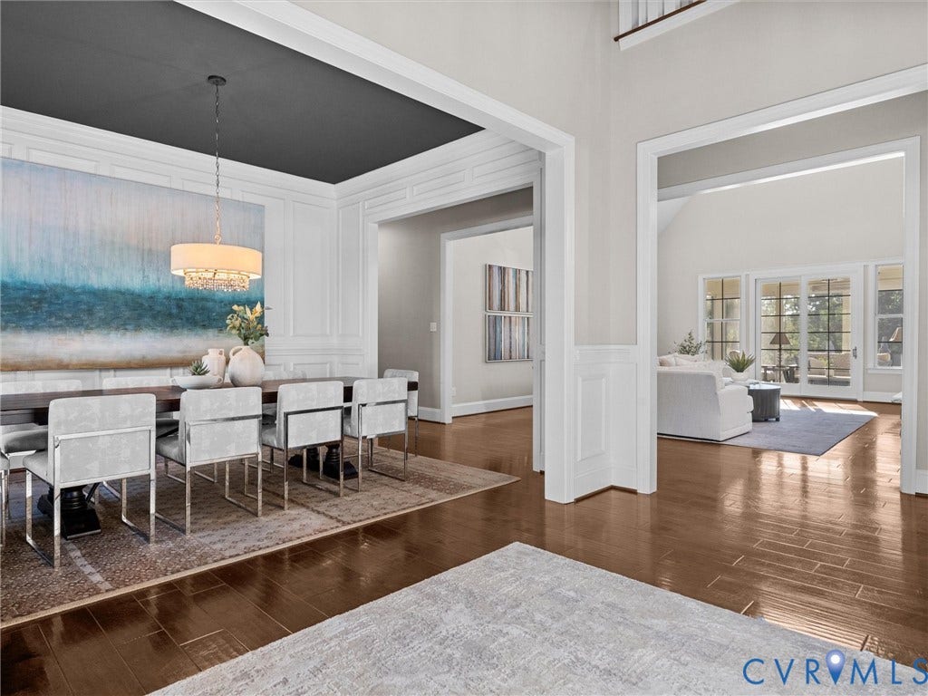 7750 Rock Cress Place, Chesterfield, VA 23120 Formal dining area featuring wainscoting, high-contrast ceiling detailing, and a multi-tiered crystal chandelier, complemented by polished wood-finish flooring