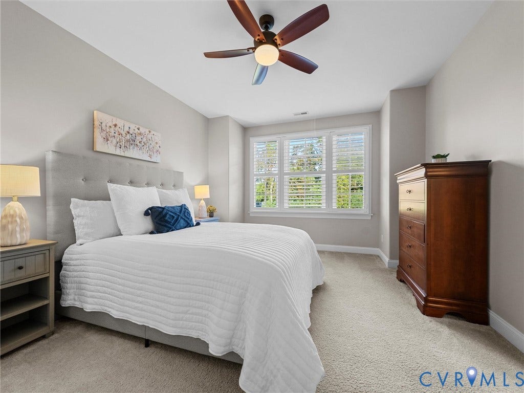 7750 Rock Cress Place, Chesterfield, VA 23120 Room featuring neutral wall tones, wall-to-wall carpeting, three-panel window with plantation shutters, and a central ceiling fan with integrated lighting
