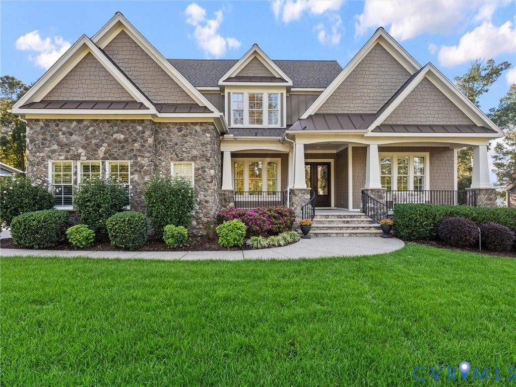 7750 Rock Cress Place, Chesterfield, VA 23120 Multi-gabled exterior featuring stone veneer, shake-style siding, metal roofing accents, and a covered front porch with square columns