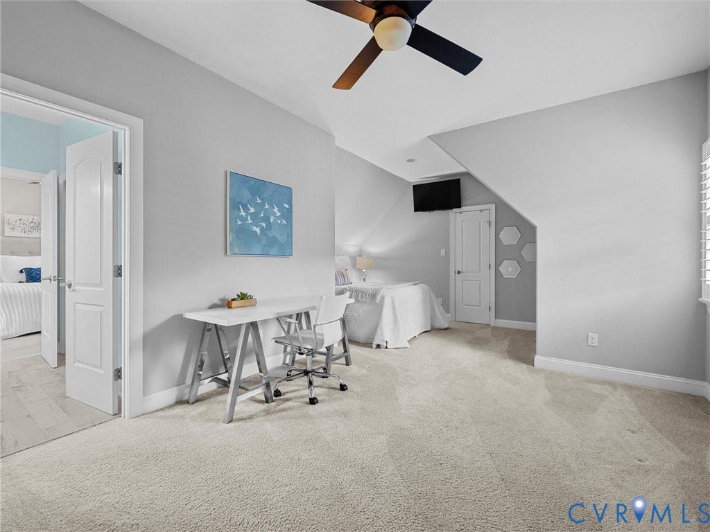 7750 Rock Cress Place, Chesterfield, VA 23120 Bedroom interior featuring neutral wall paint, high-pile carpeting, vaulted ceilings, and a ceiling fan with integrated lighting
