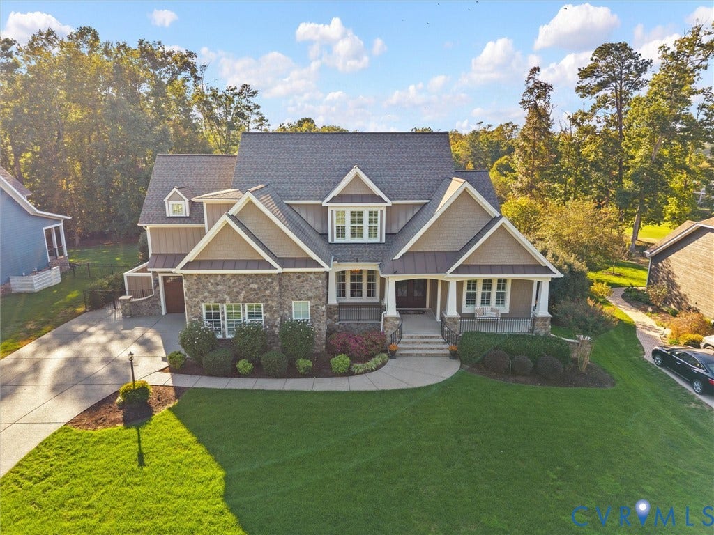 7750 Rock Cress Place, Chesterfield, VA 23120 Two-story residence featuring stone and composite siding, a multi-gabled roofline, a covered front porch with decorative columns, and a multi-car concrete driveway