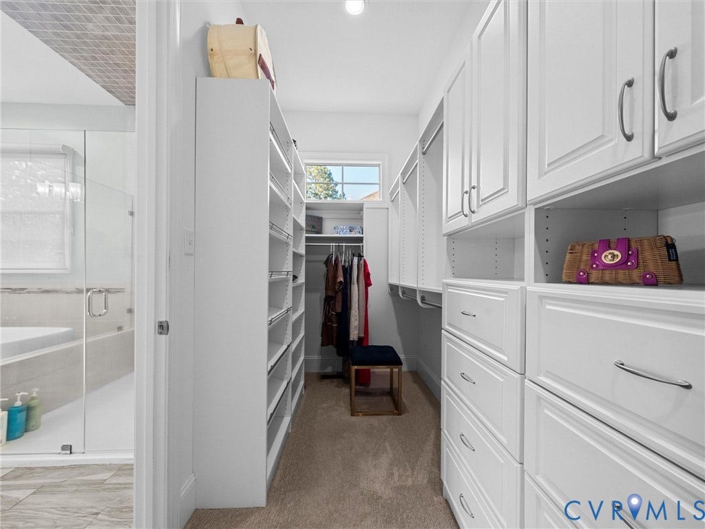 7750 Rock Cress Place, Chesterfield, VA 23120 Walk-in closet featuring floor-to-ceiling white cabinetry, built-in shelving, multiple drawers with metal hardware, and a window