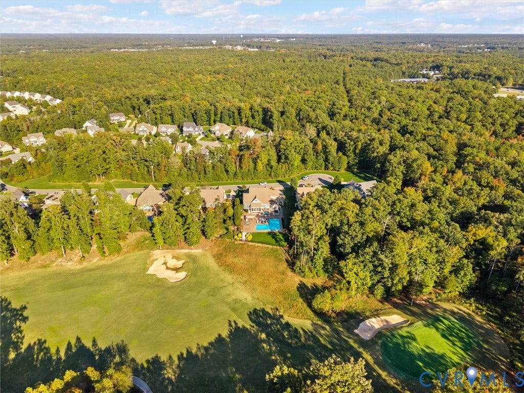 7750 Rock Cress Place, Chesterfield, VA 23120 Aerial perspective showcasing a residential property with a swimming pool, situated on a golf course featuring sand bunkers and expansive green space