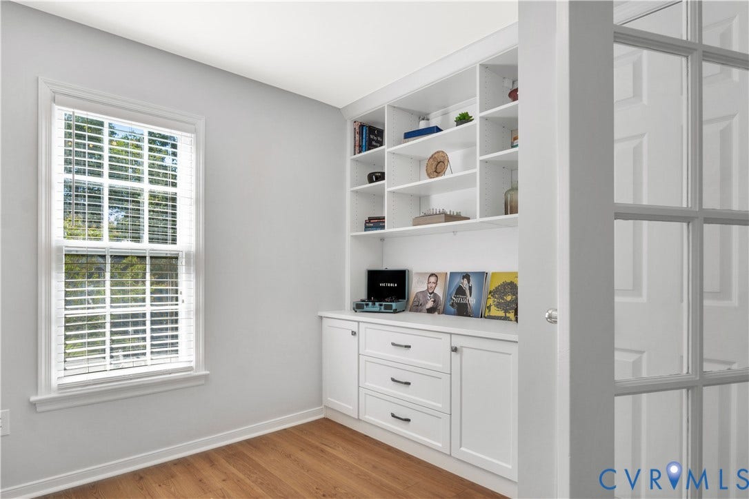 2724 Glen Point Circle, Henrico, VA 23233 Wood-finish flooring, built-in shelving, white cabinetry with dark hardware, and a multi-pane window