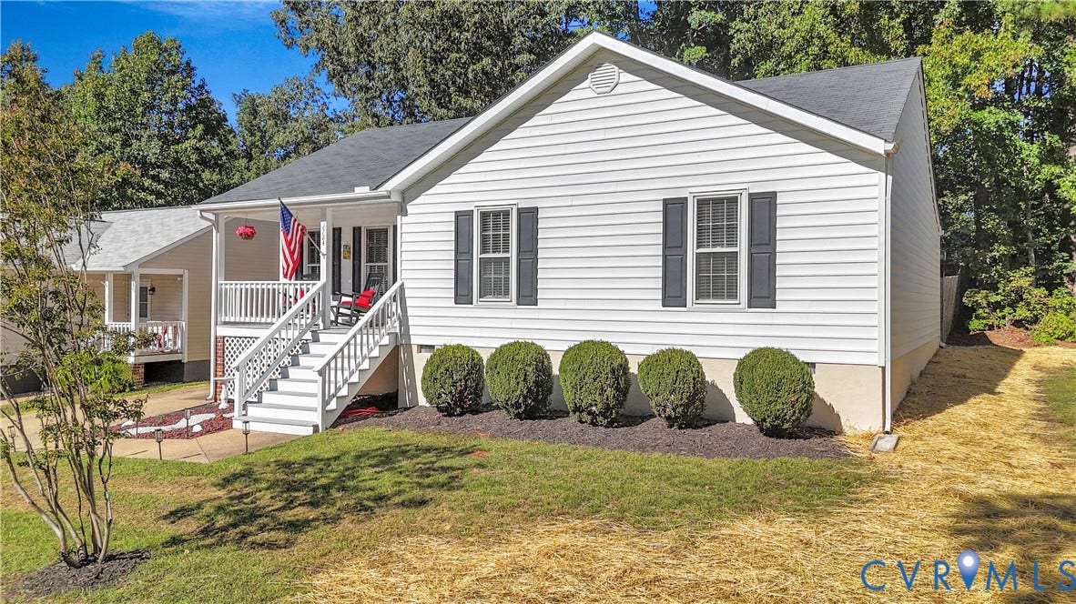 2724 Glen Point Circle, Henrico, VA 23233 White siding exterior with a covered porch, white railing, and dark shutters