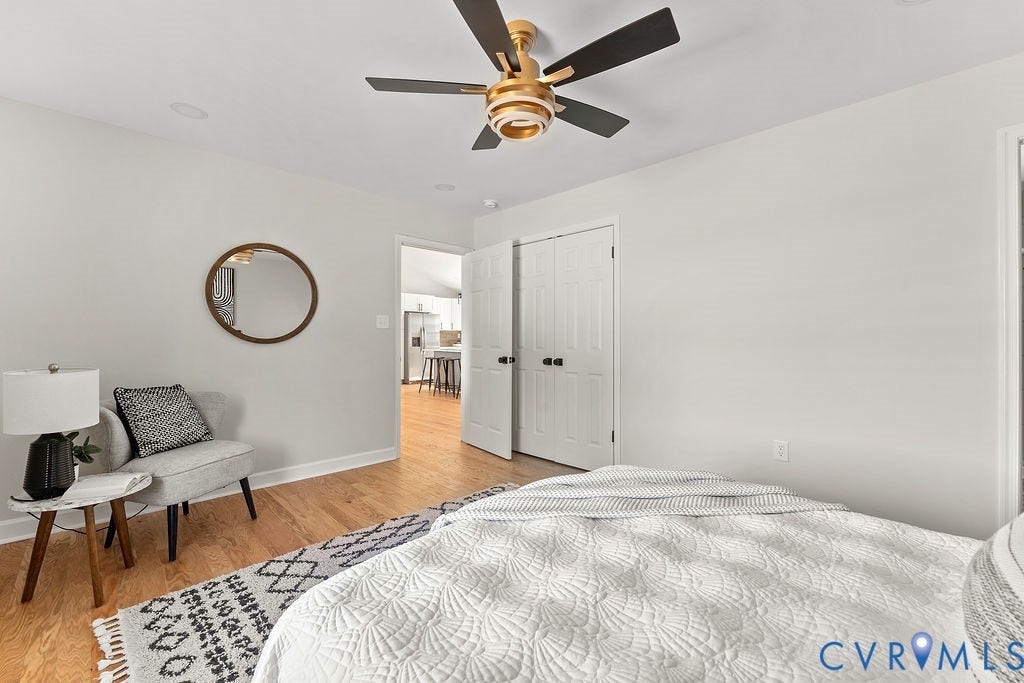 Recessed lighting, wood-finish flooring, and a contemporary ceiling fan with gold-tone accents