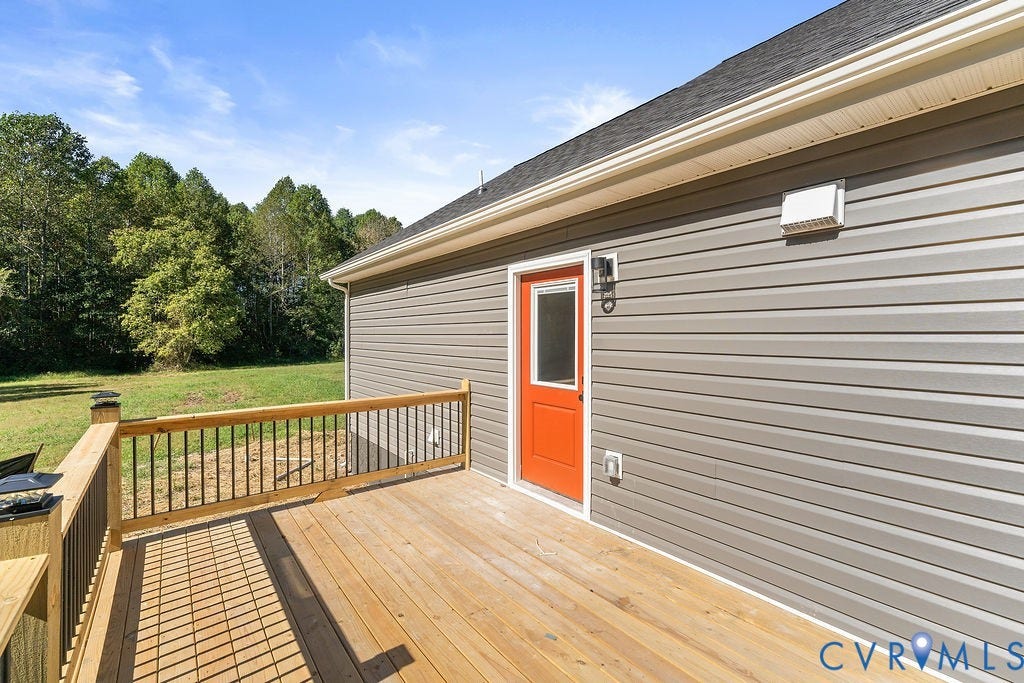 Wood deck with natural finish and black spindle railing