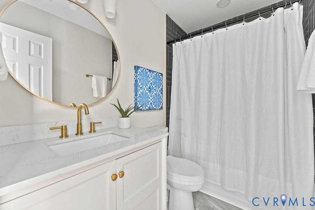 White shaker vanity with gold-finish hardware, rectangular undermount sink, and a quartz countertop