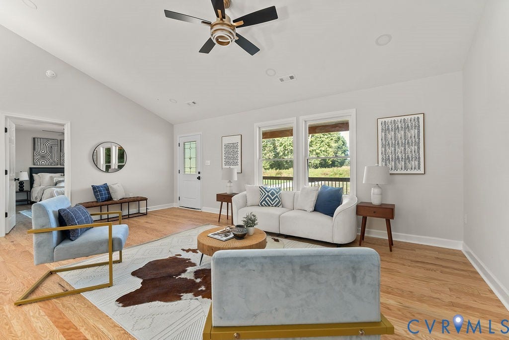 Vaulted ceiling with a contemporary ceiling fan, three pane windows, wood-finish flooring, and recessed lighting