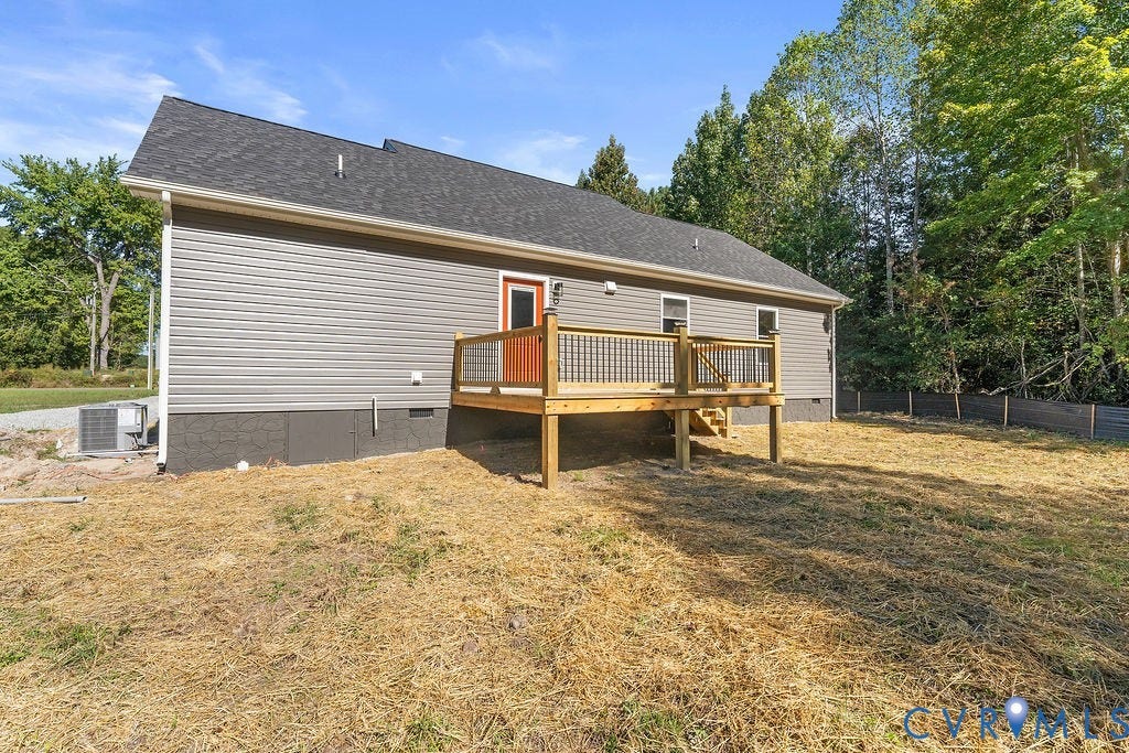 Gray horizontal siding with dark shingle roof and white gutters