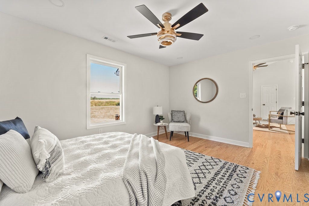 Hardwood flooring, recessed lighting, ceiling fan with black blades, white window trim, and white baseboards