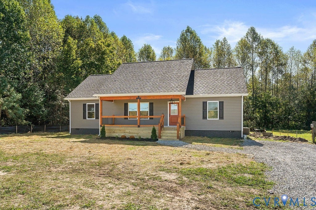 Ranch-style exterior with gray siding, a covered front porch featuring a natural wood ceiling, dark railings, and an orange front door