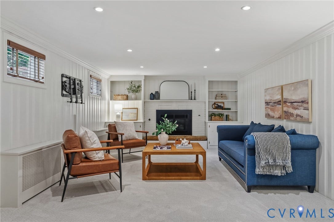 3700 Wakefield Road, Stratofrd Hills, Richmond, VA 23235 Vertical paneled walls, wood-burning fireplace with white brick surround, built-in shelving, recessed lighting, and wall-to-wall carpeting
