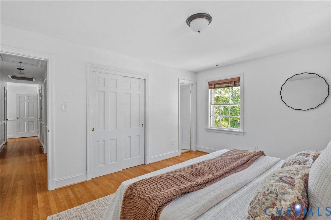 3700 Wakefield Road, Stratofrd Hills, Richmond, VA 23235 Interior space featuring wood-finish flooring, white paneled closet doors, and a double-hung window with wood-trim finish