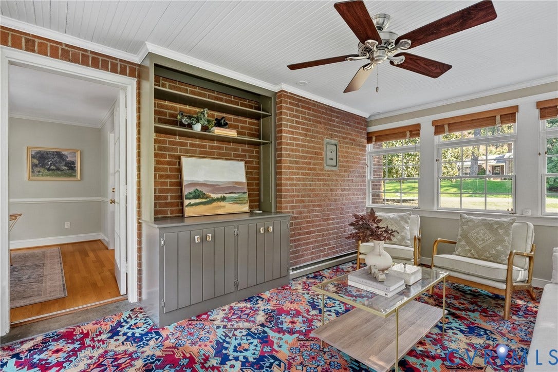 3700 Wakefield Road, Stratofrd Hills, Richmond, VA 23235 Exposed brick accent wall with built-in shelving, tongue-and-groove ceiling, multi-pane windows, and wooden-blade ceiling fan