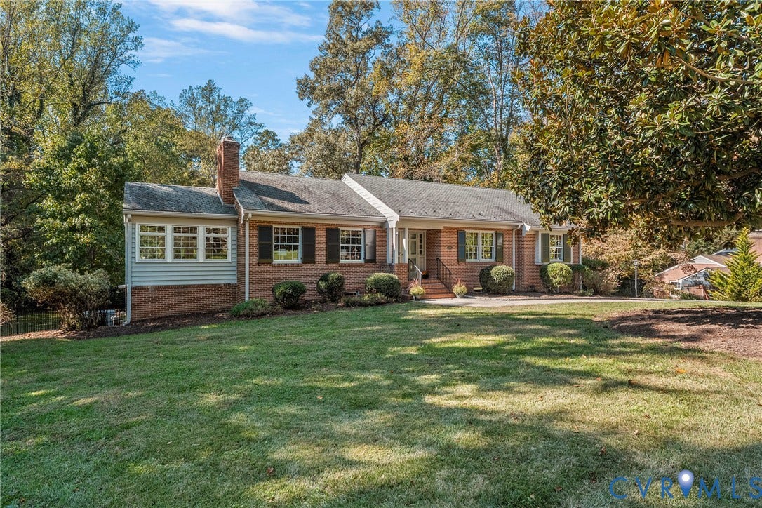 3700 Wakefield Road, Stratofrd Hills, Richmond, VA 23235 Single-story brick exterior featuring a multi-gabled roofline, functional shutters, an exterior chimney, and a sprawling front lawn