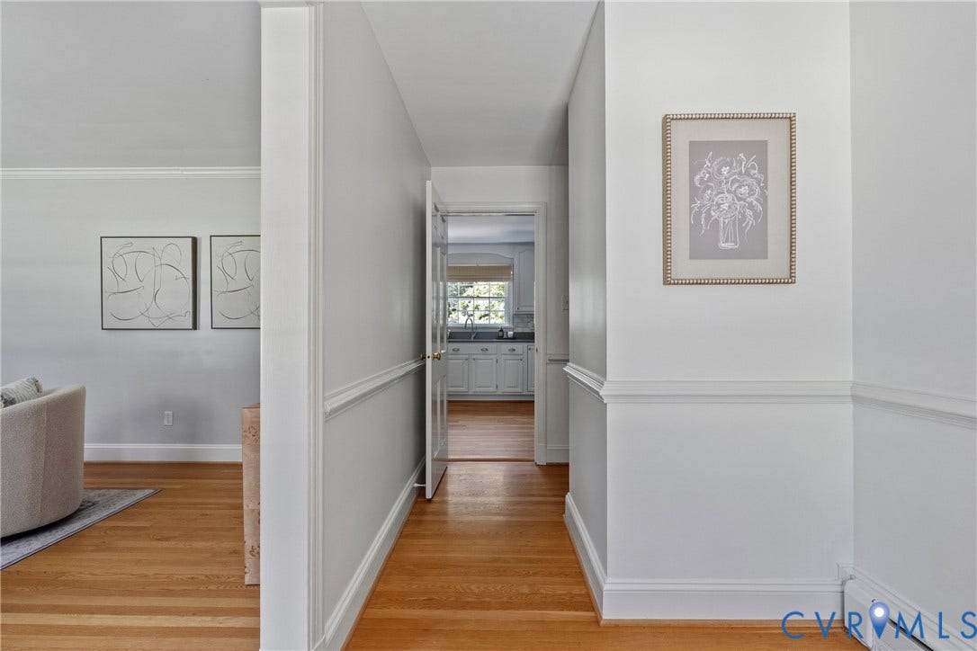 3700 Wakefield Road, Stratofrd Hills, Richmond, VA 23235 Interior hallway featuring wood-finish flooring, white walls, and traditional chair rail molding