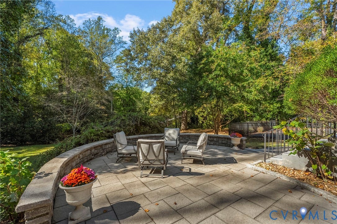 3700 Wakefield Road, Stratofrd Hills, Richmond, VA 23235 Stone paver patio featuring a curved retaining wall, built-in stone masonry, and mature tree-lined surroundings