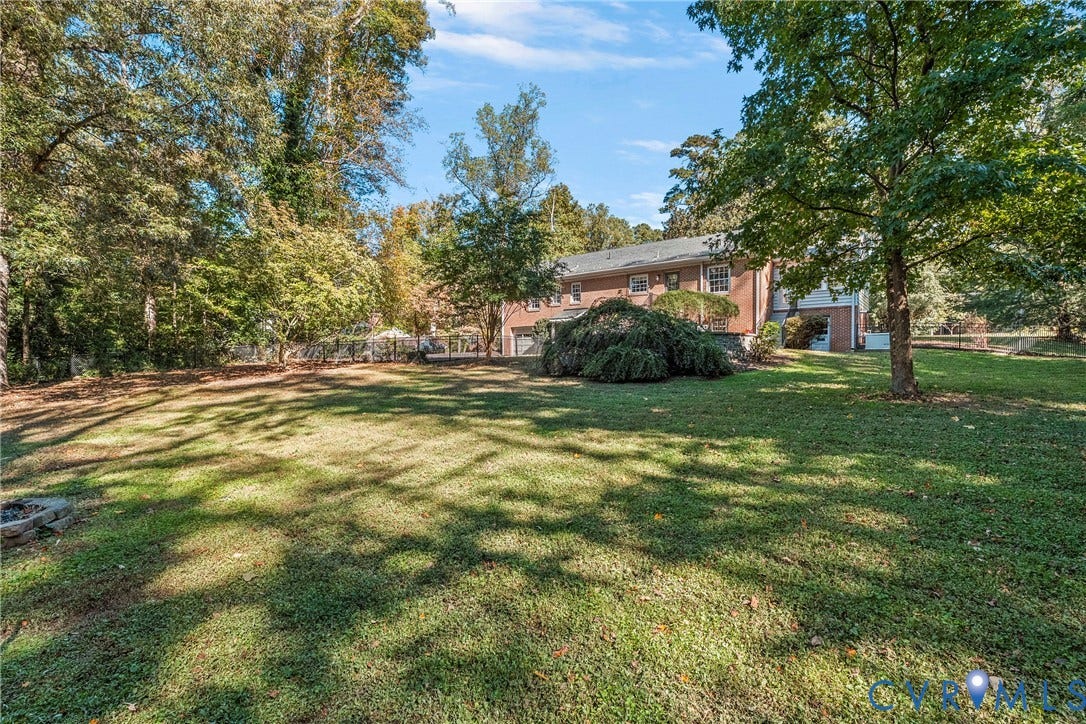 3700 Wakefield Road, Stratofrd Hills, Richmond, VA 23235 Expansive backyard featuring a manicured lawn, established shade trees, perimeter fencing, and a brick exterior residence