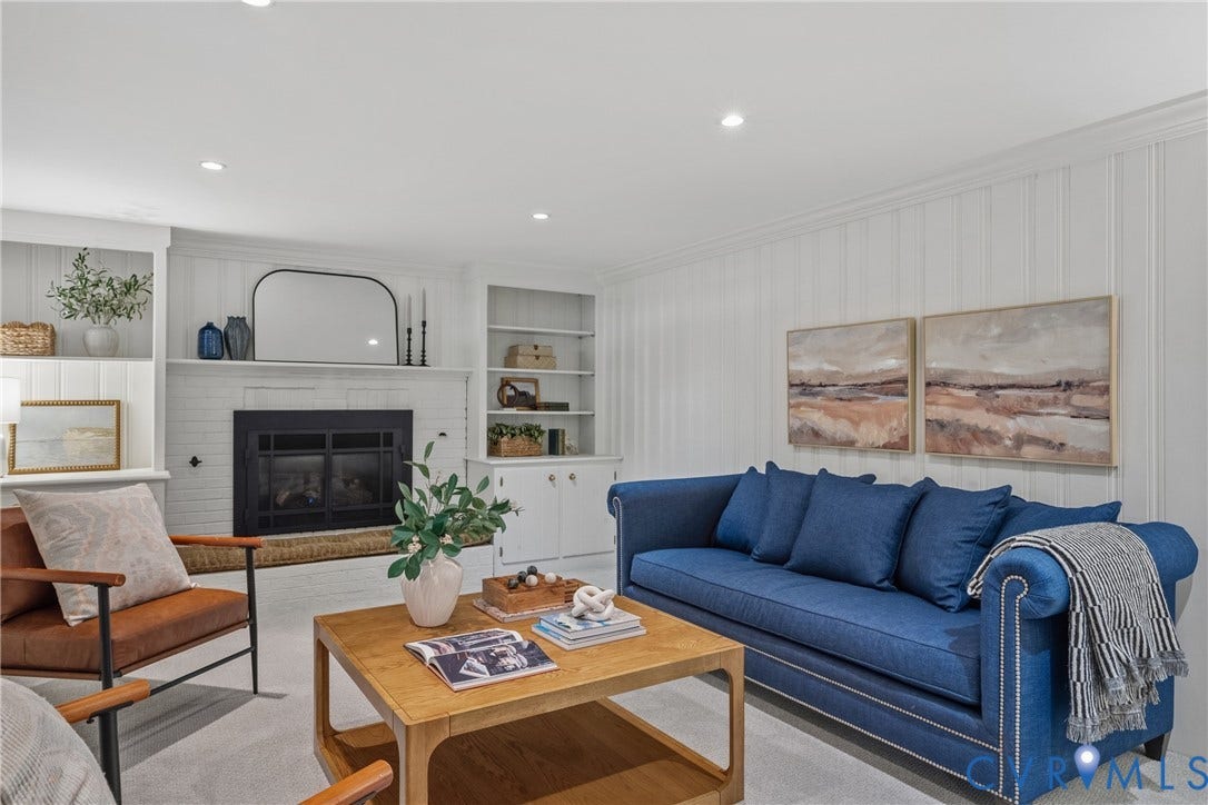 3700 Wakefield Road, Stratofrd Hills, Richmond, VA 23235 Fireplace with custom built-in shelving, vertical wood wall paneling, and recessed lighting