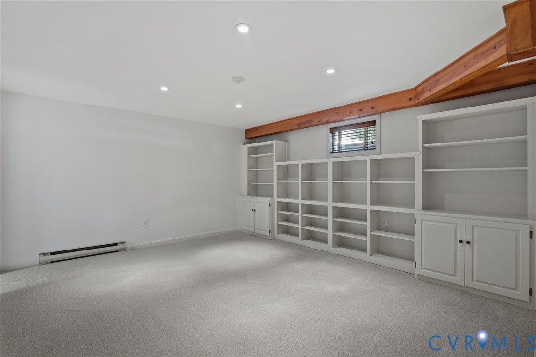 3700 Wakefield Road, Stratofrd Hills, Richmond, VA 23235 Room featuring exposed natural wood ceiling beams, expansive wall-to-wall built-in shelving, and recessed lighting