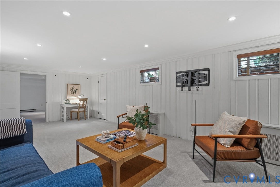3700 Wakefield Road, Stratofrd Hills, Richmond, VA 23235 Vertical wood-paneled walls, neutral carpeting, recessed ceiling lighting, and multiple horizontal windows with wood-tone framing
