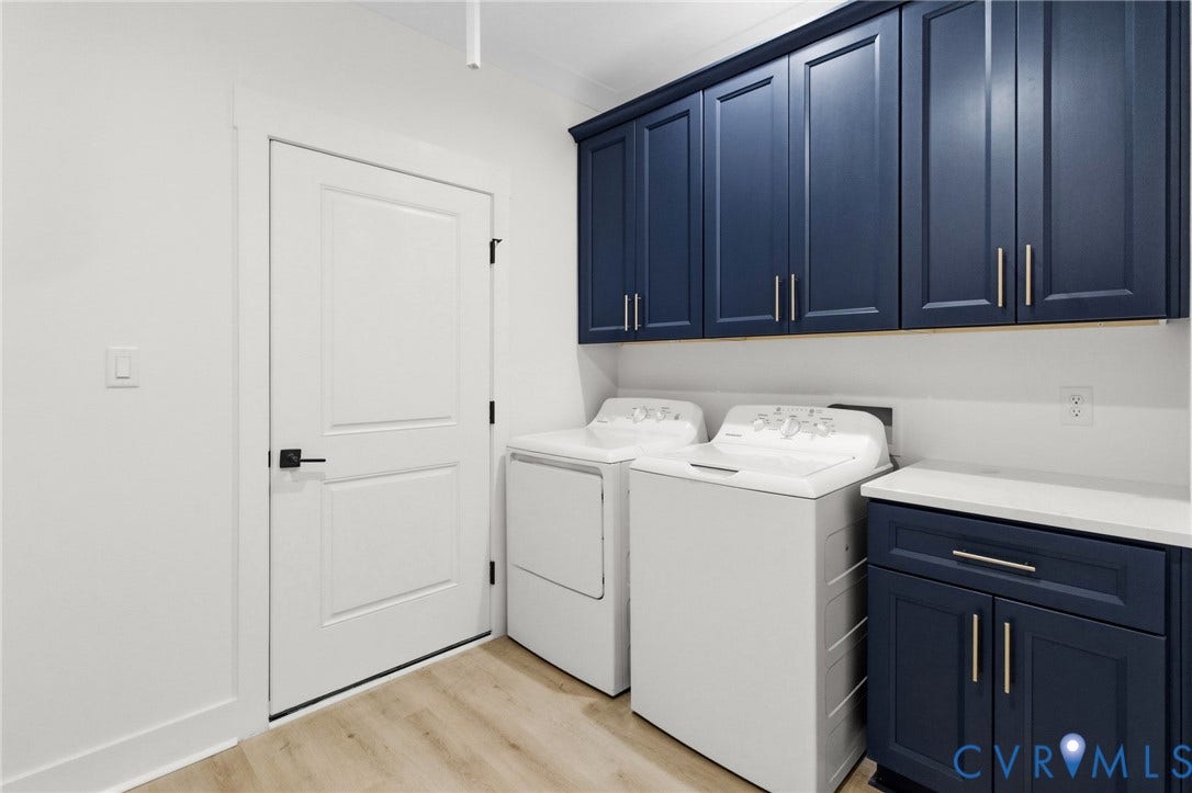 34356 Chinquapin Road, Waverly, VA 23890 Laundry area featuring navy blue cabinetry, white countertops, wood-finish flooring, and white interior door