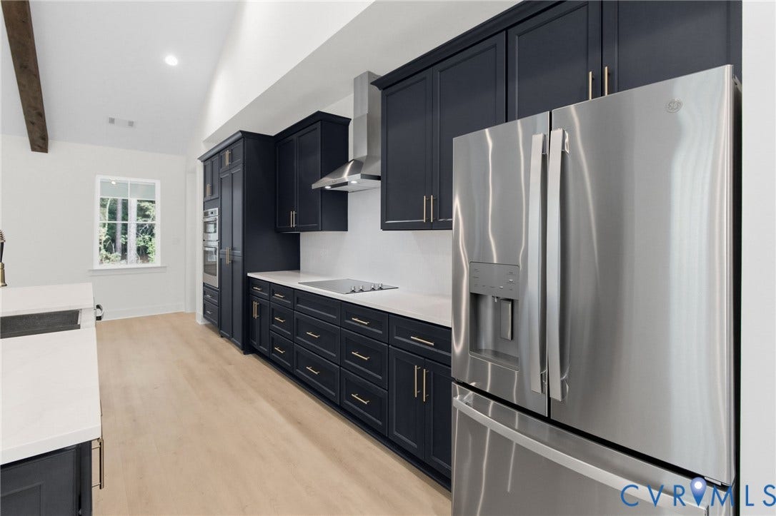 34356 Chinquapin Road, Waverly, VA 23890 Kitchen featuring dark cabinetry, stainless steel appliances, light countertops, and wood-finish flooring