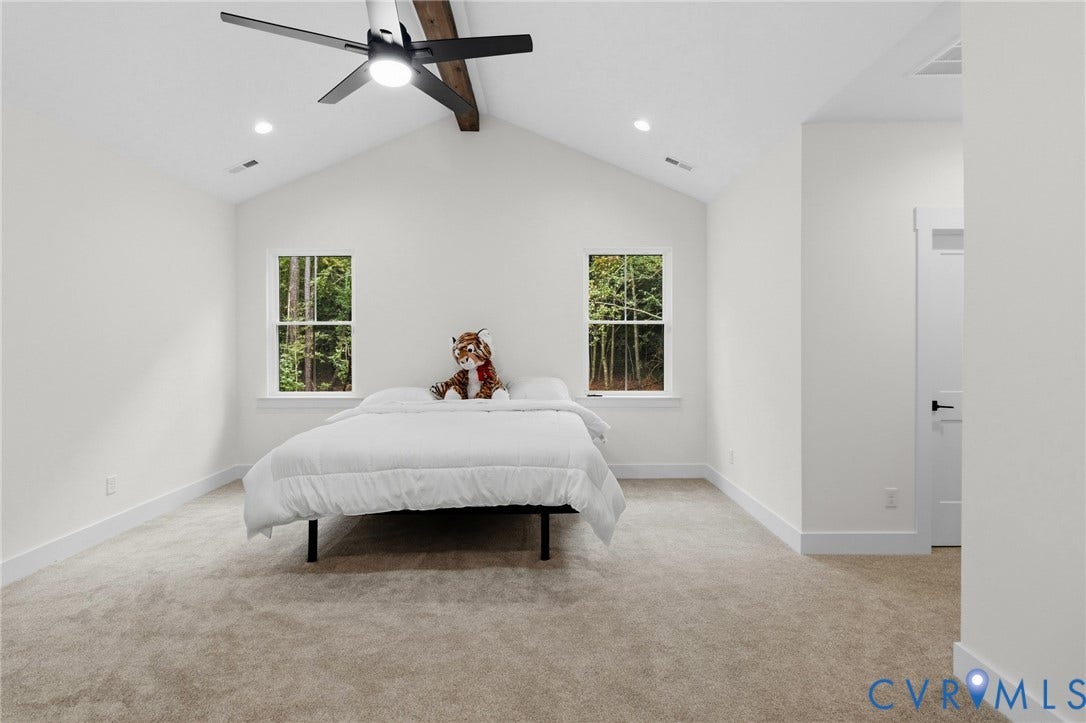 34356 Chinquapin Road, Waverly, VA 23890 Vaulted ceiling with exposed wood beam, modern ceiling fan, recessed lighting, and dual windows