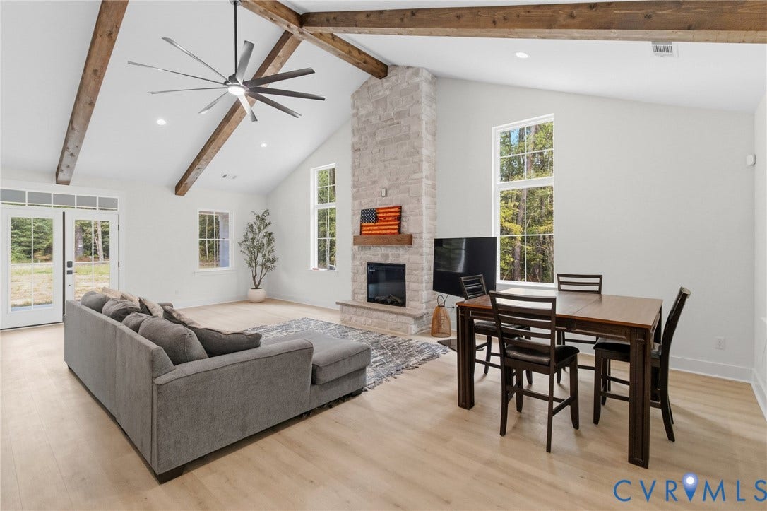 34356 Chinquapin Road, Waverly, VA 23890 Vaulted ceiling with exposed wood beams, stone-clad fireplace, wood-finish flooring, recessed lighting, and French doors