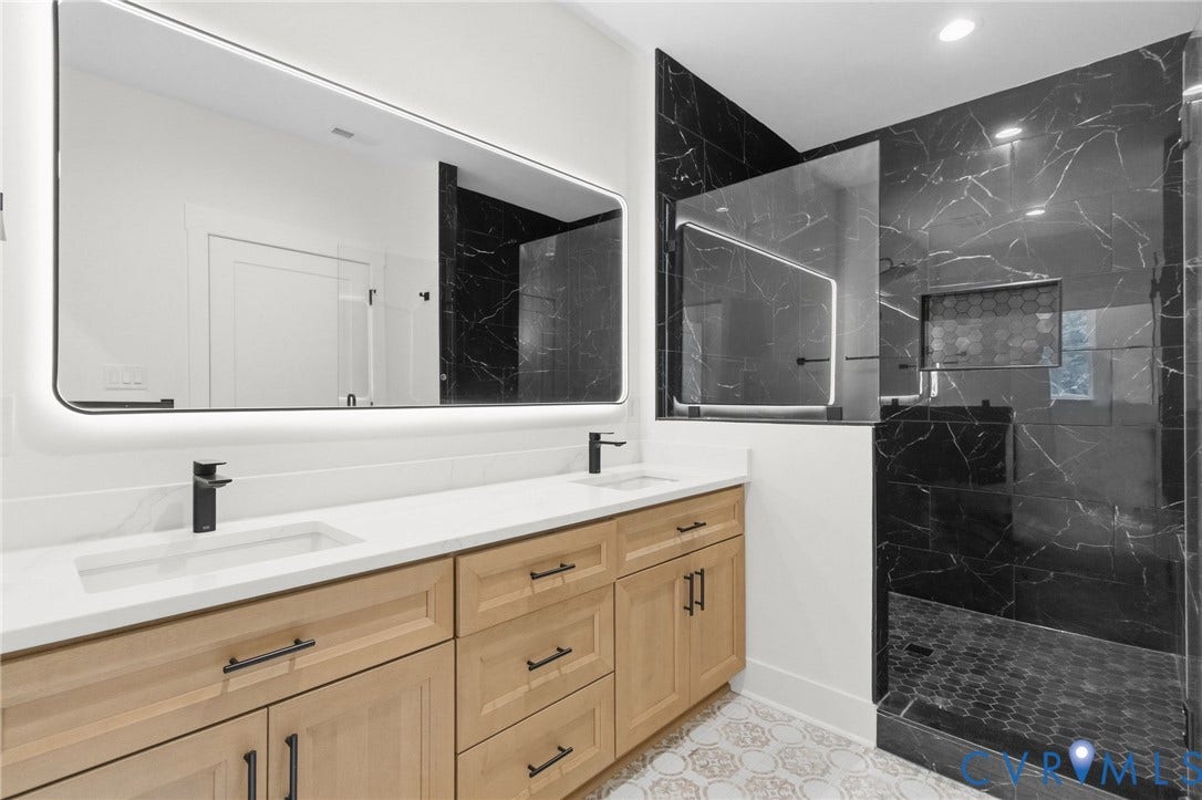 34356 Chinquapin Road, Waverly, VA 23890 Dual vanity with light wood-finish cabinetry, white countertops, and matte black fixtures