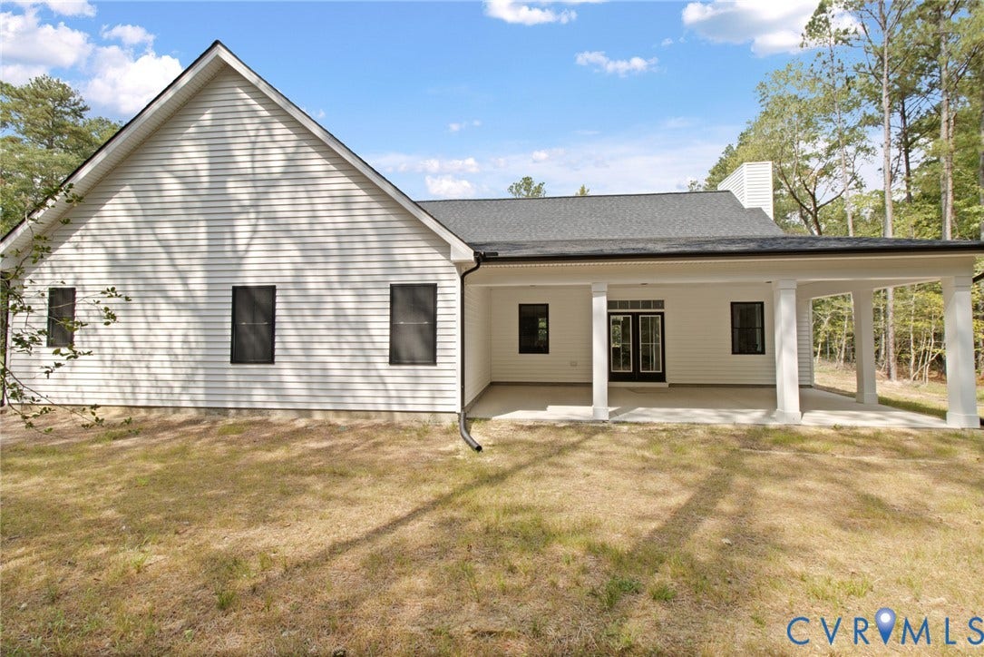 34356 Chinquapin Road, Waverly, VA 23890 Rear exterior with covered patio, white siding, dark-framed windows, and double French doors