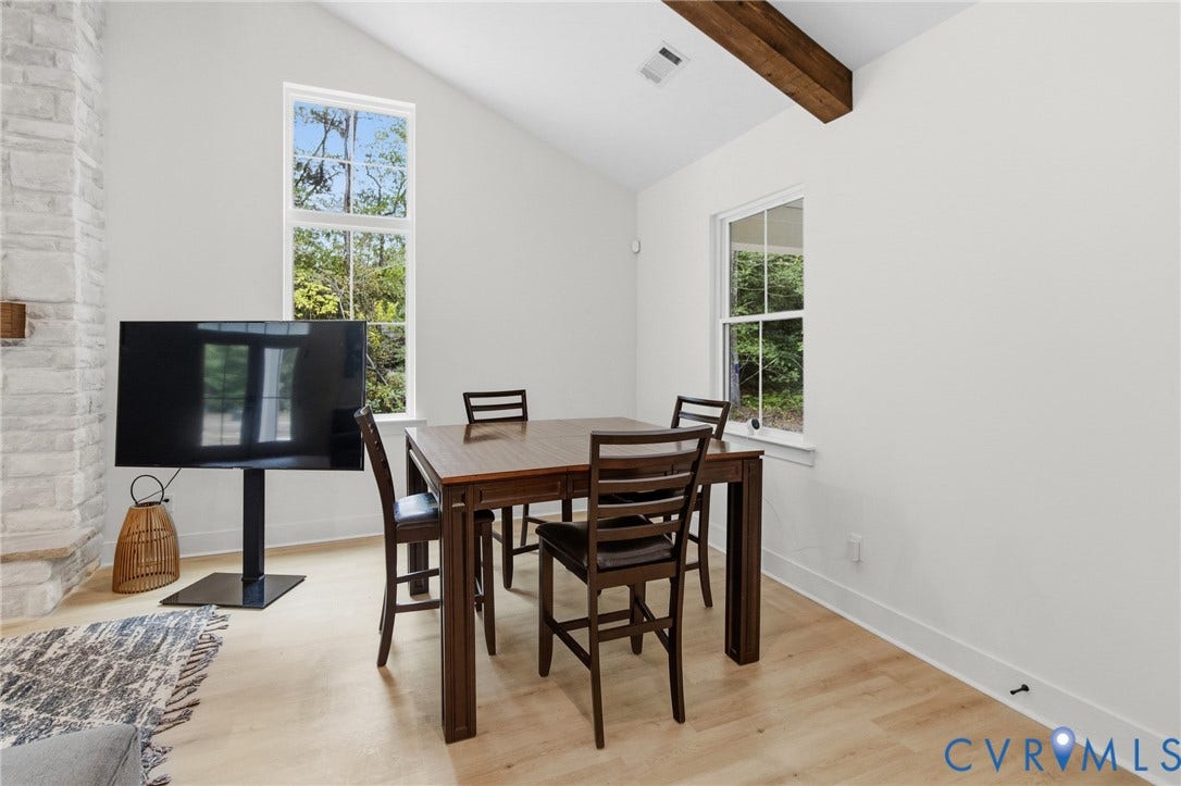 34356 Chinquapin Road, Waverly, VA 23890 Vaulted ceiling with exposed wood beam, wood-finish flooring, and white painted walls