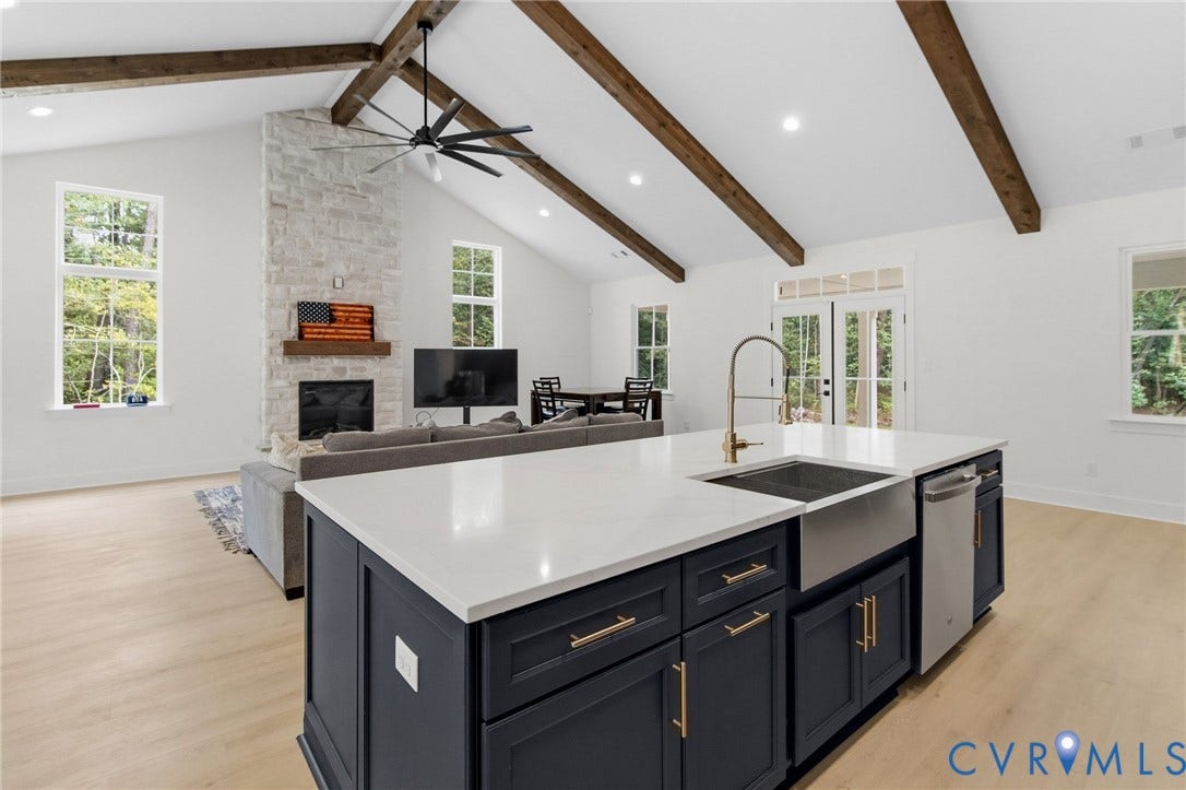 34356 Chinquapin Road, Waverly, VA 23890 Expansive open-concept space featuring a vaulted ceiling with exposed wood beams