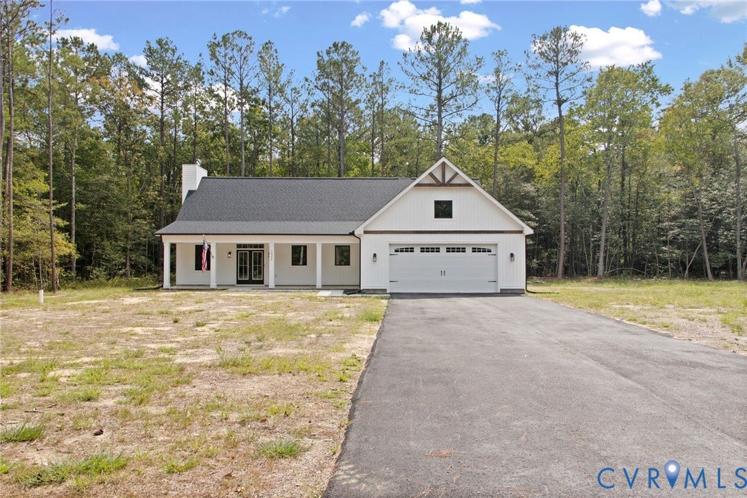 34356 Chinquapin Road, Waverly, VA 23890 Craftsman-style exterior with white siding, covered front porch, double entry doors, two-car garage, and a paved driveway