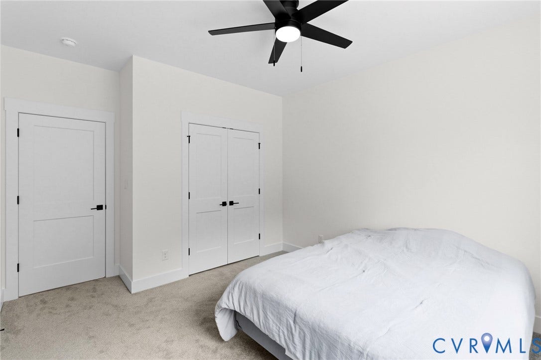 34356 Chinquapin Road, Waverly, VA 23890 Neutral wall finishes with a ceiling-mounted fan, plush carpet flooring, and white trim