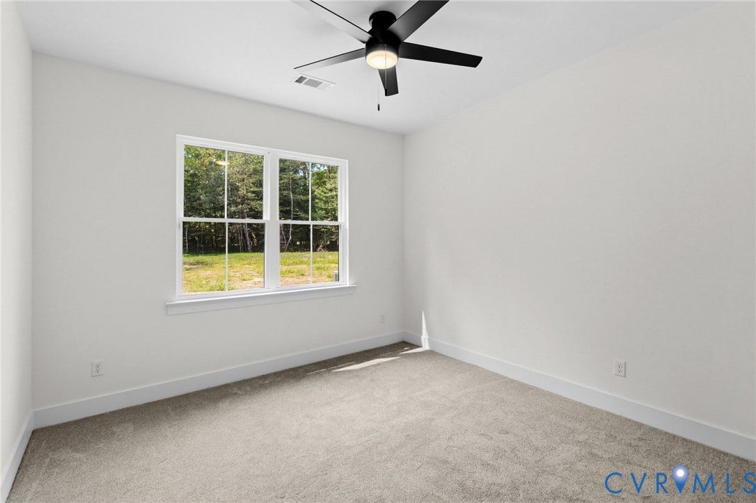34356 Chinquapin Road, Waverly, VA 23890 Bright interior space featuring a window, ceiling fan with integrated lighting, and neutral carpeting
