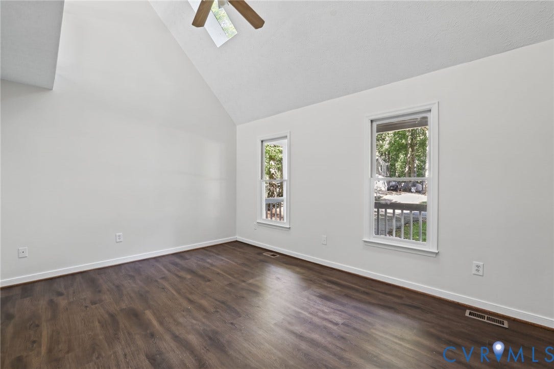 13811 Buck Rub Drive, Chesterfield, VA 23112 Vaulted ceiling with skylight, wood-finish flooring, two windows, and ceiling fan