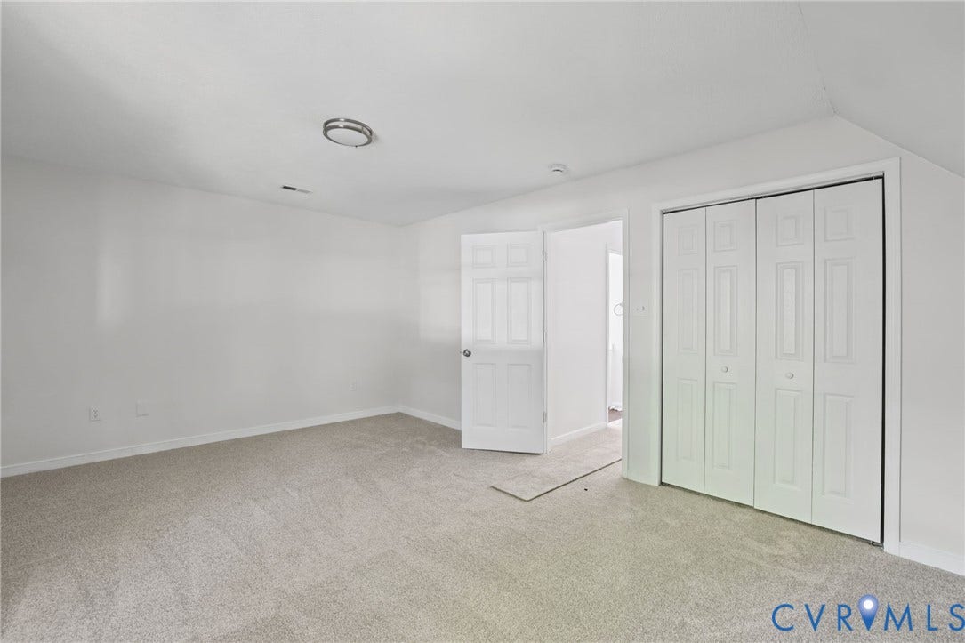 13811 Buck Rub Drive, Chesterfield, VA 23112 Light gray carpet flooring, white walls, white bi-fold closet doors, and a flush mount ceiling light