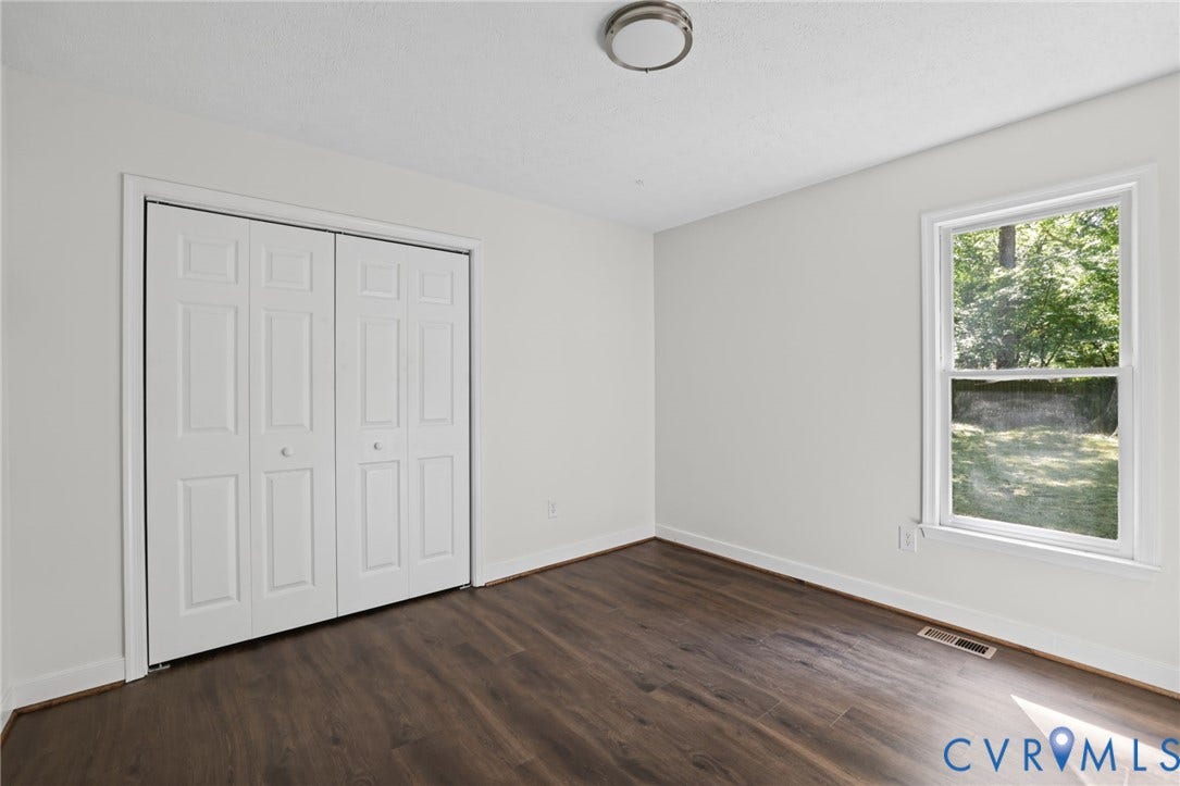 13811 Buck Rub Drive, Chesterfield, VA 23112 Freshly painted interior with wood-finish flooring, a double bi-fold closet, and a single-hung window