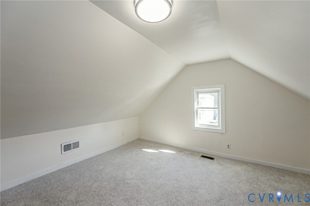 2011 Chicago Avenue, Richmond, VA 23224 Finished room with neutral carpet flooring, vaulted ceilings, and a central overhead flush-mount light fixture