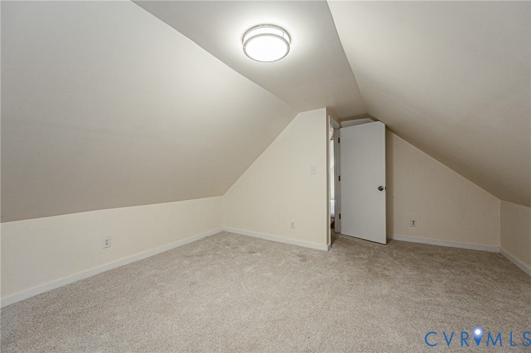 2011 Chicago Avenue, Richmond, VA 23224 Finished interior space with vaulted ceilings, neutral wall tones, wall-to-wall carpeting, and a flush-mount circular ceiling light