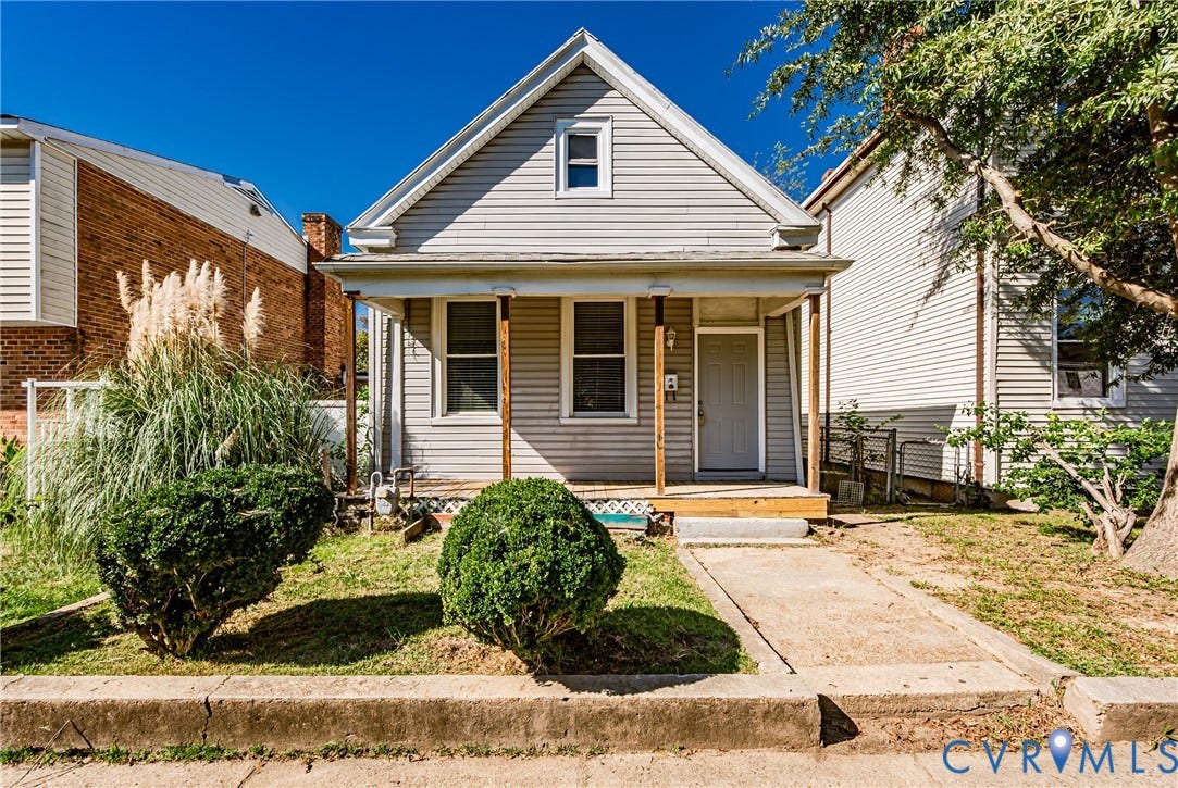 2011 Chicago Avenue, Richmond, VA 23224 Gable-front exterior featuring horizontal siding, a covered front porch with wood-finish supports, and a paved walkway