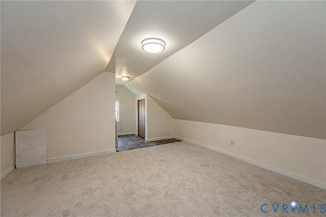 2011 Chicago Avenue, Richmond, VA 23224 Finished attic space featuring vaulted ceilings, neutral wall-to-wall carpeting, dual flush-mount ceiling light fixtures, and a built-in closet