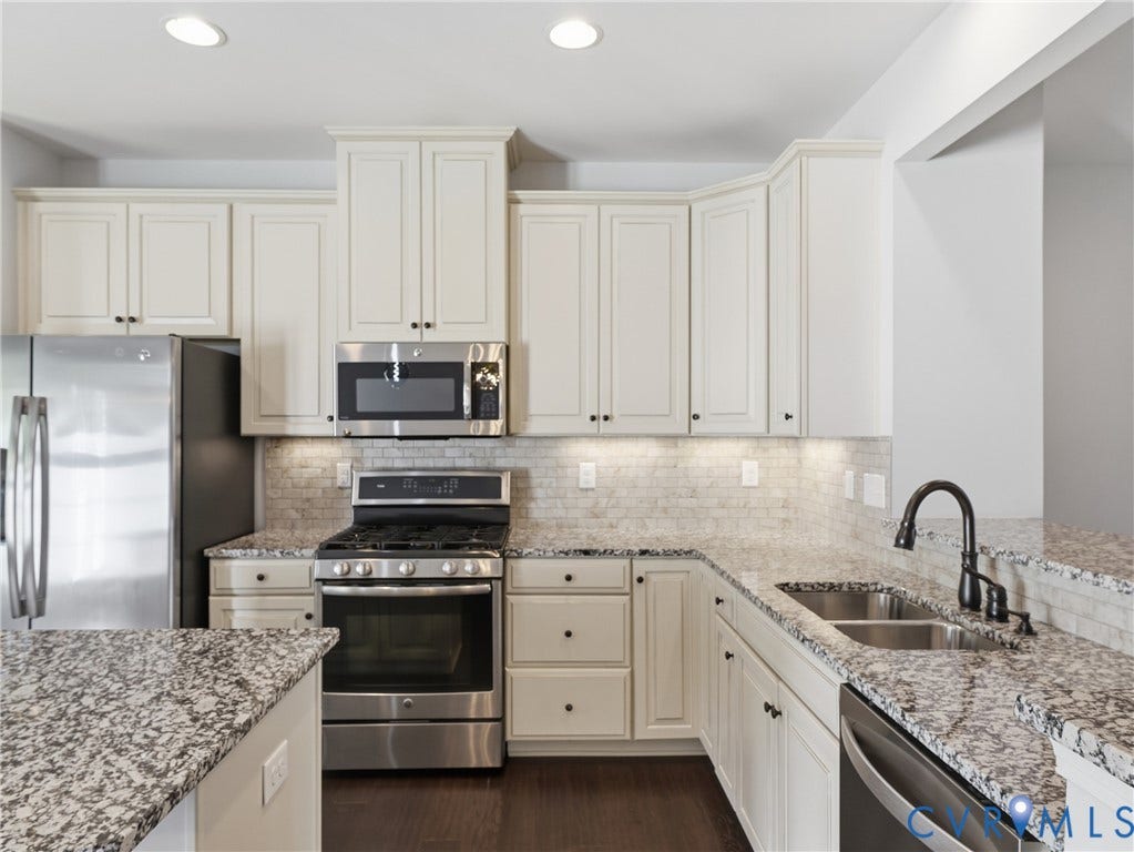 5612 Riverside Heights Way, Richmond, VA 23225 This modern kitchen is a chef's dream with a gas range, double sink, newer dishwasher (2024) and ample counterspace and storage space, including a pantry.